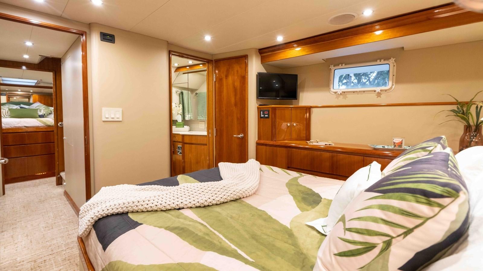 a hotel room with a bed and tv aboard WELL DONE Yacht for Sale