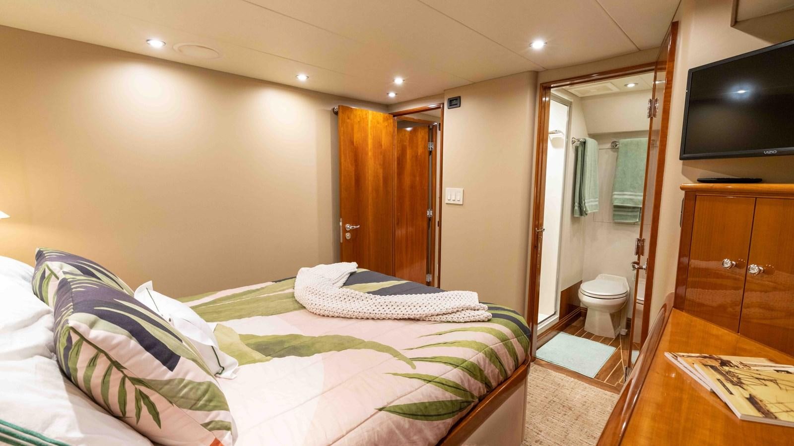 a hotel room with a bed and tv aboard WELL DONE Yacht for Sale