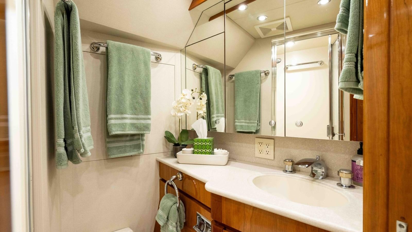 a bathroom with a large mirror aboard WELL DONE Yacht for Sale
