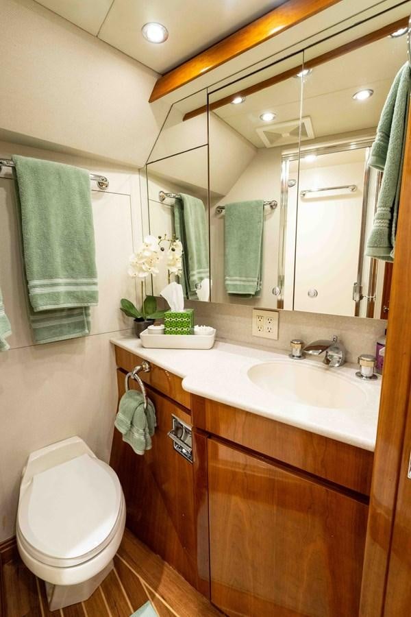 a bathroom with a toilet and a sink aboard WELL DONE Yacht for Sale
