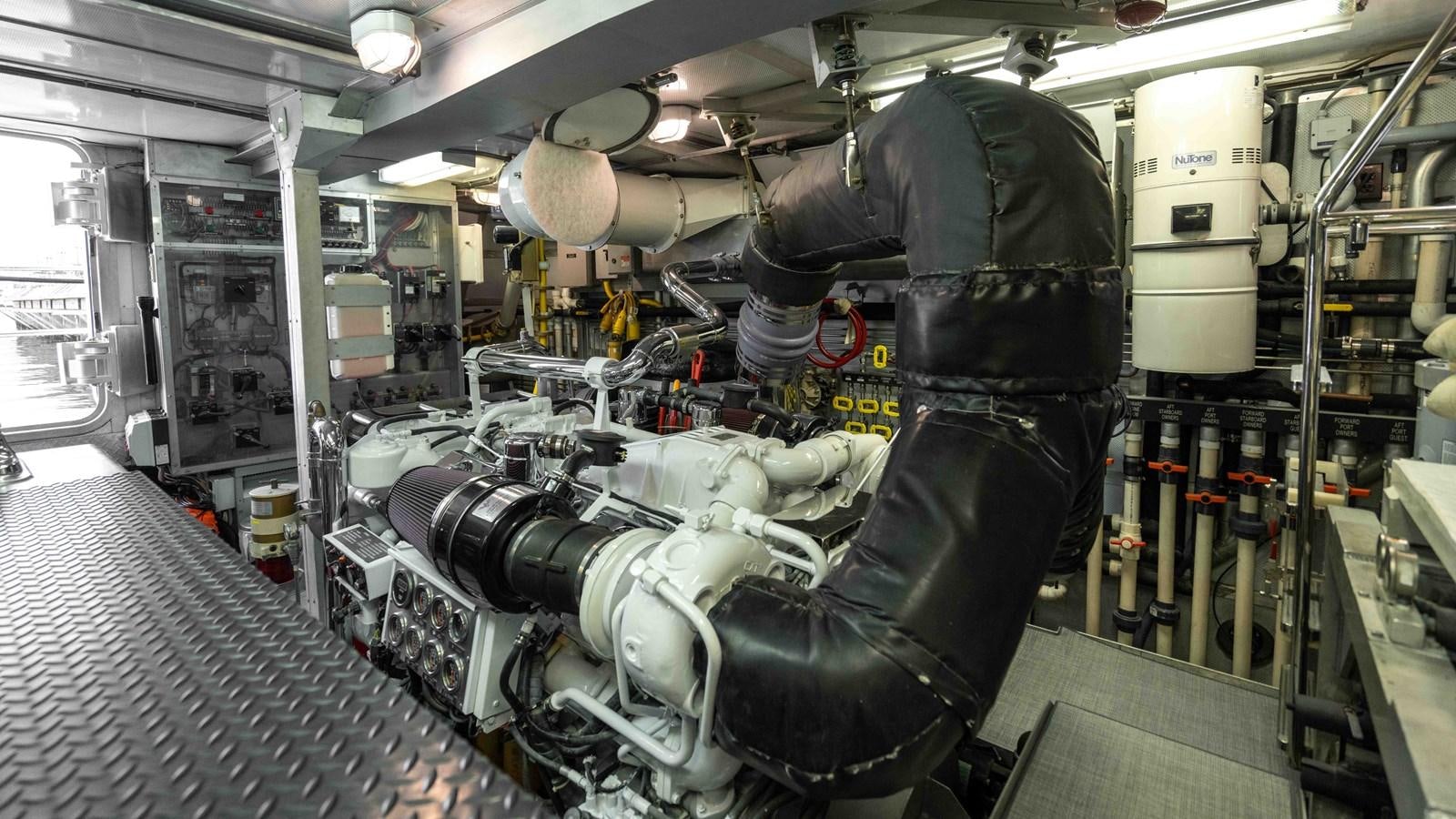 a person working on a machine aboard WELL DONE Yacht for Sale