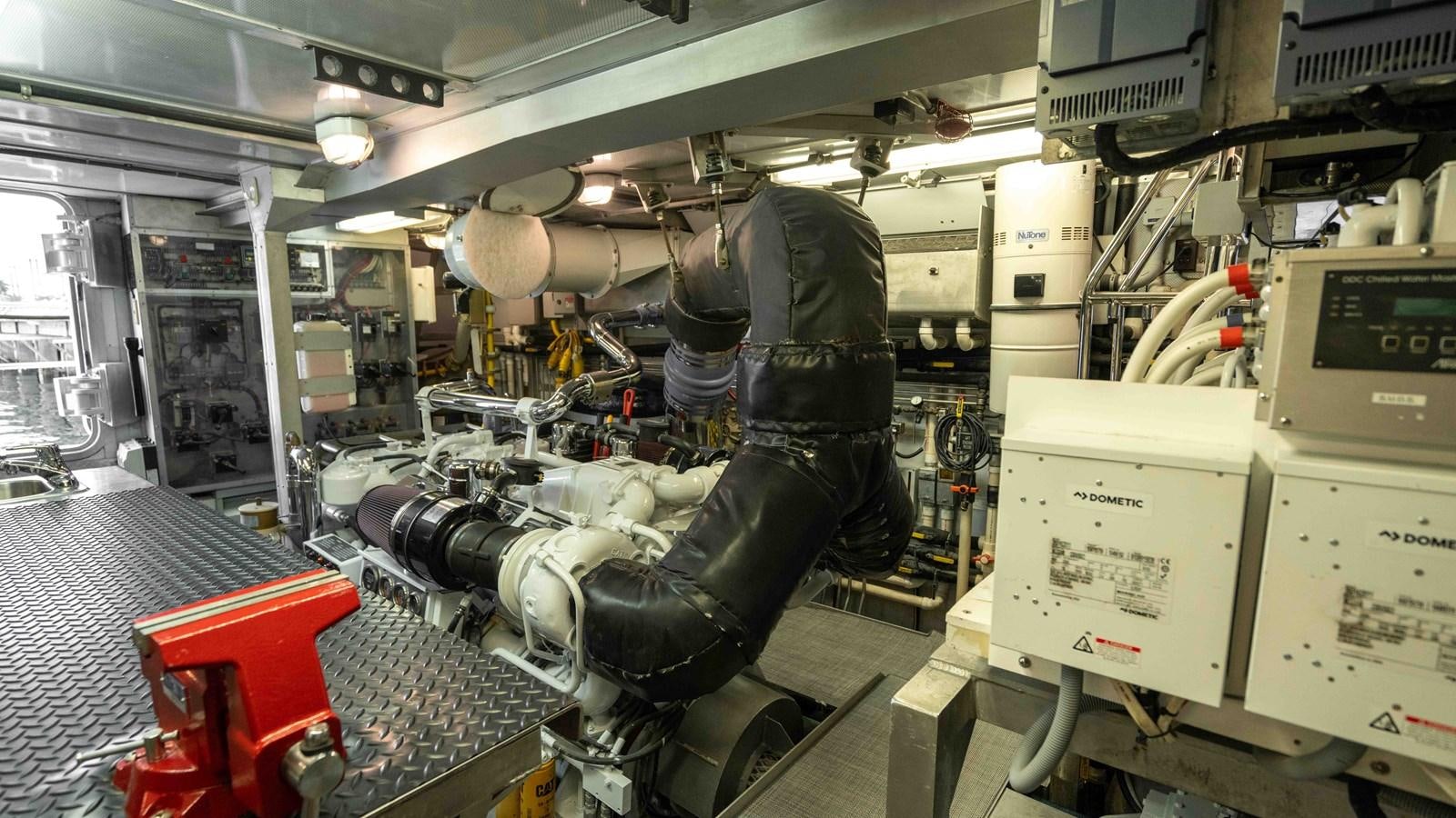 a person in a black suit working in a factory aboard WELL DONE Yacht for Sale