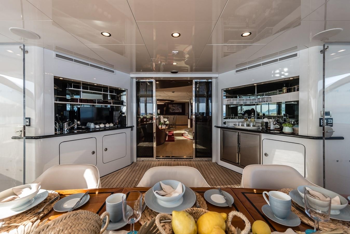 a kitchen with a dining table aboard FLYING MANTA Yacht for Sale