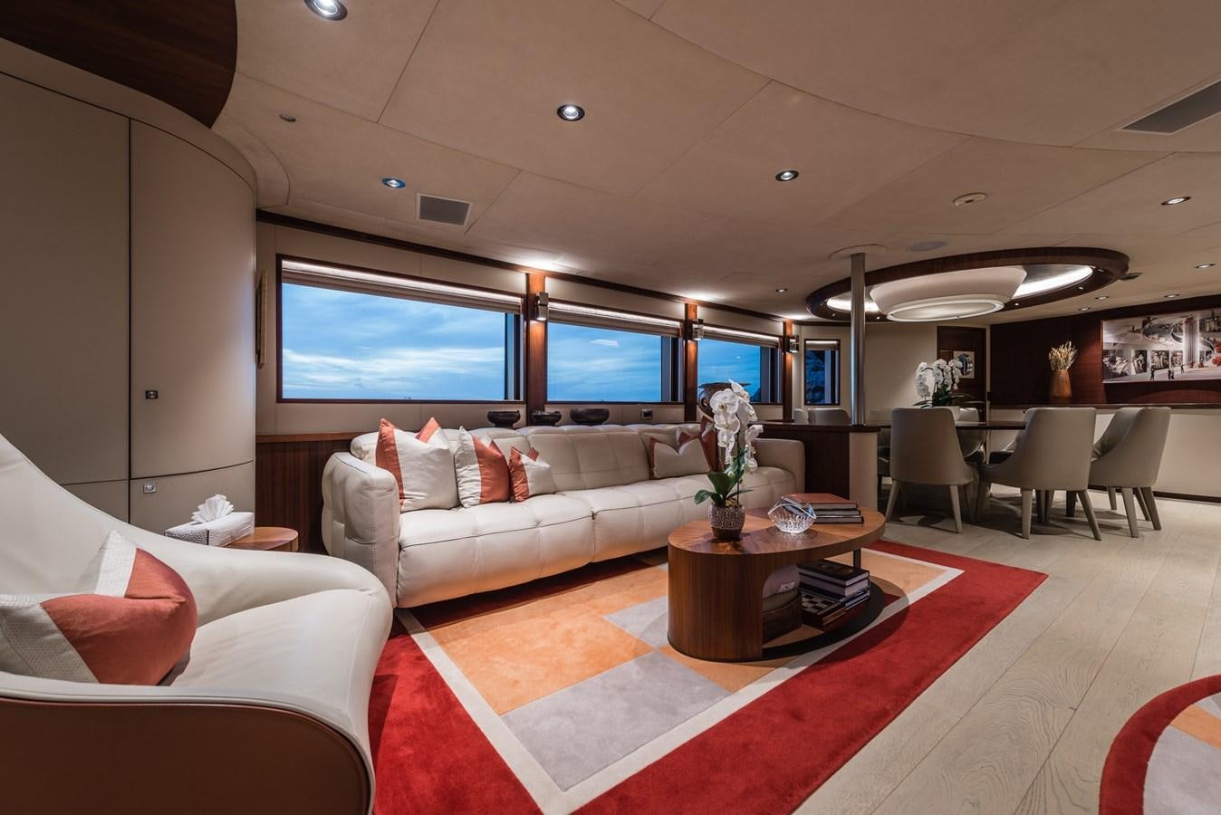 a living room with a red rug aboard FLYING MANTA Yacht for Sale