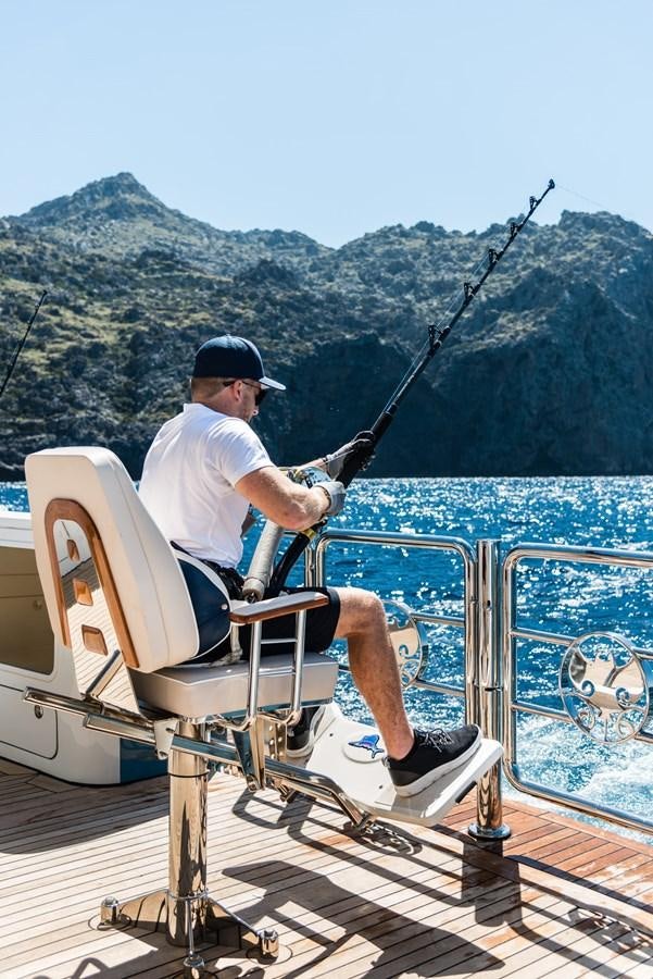 a man fishing on a boat aboard FLYING MANTA Yacht for Sale