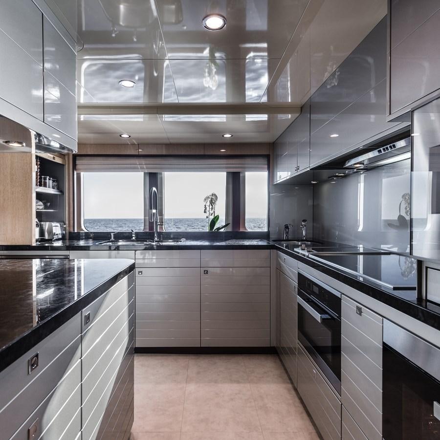 a kitchen with a large island aboard FLYING MANTA Yacht for Sale