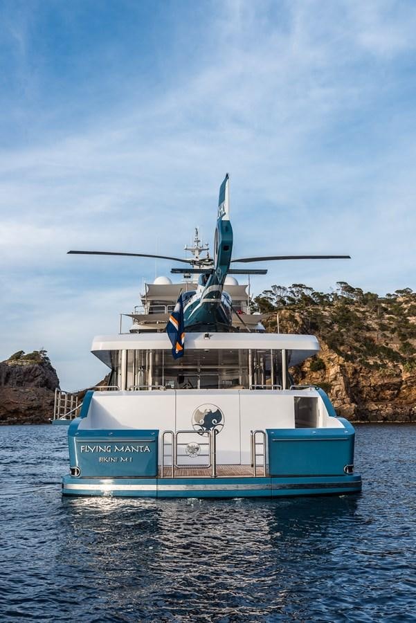 a helicopter flying over a boat aboard FLYING MANTA Yacht for Sale