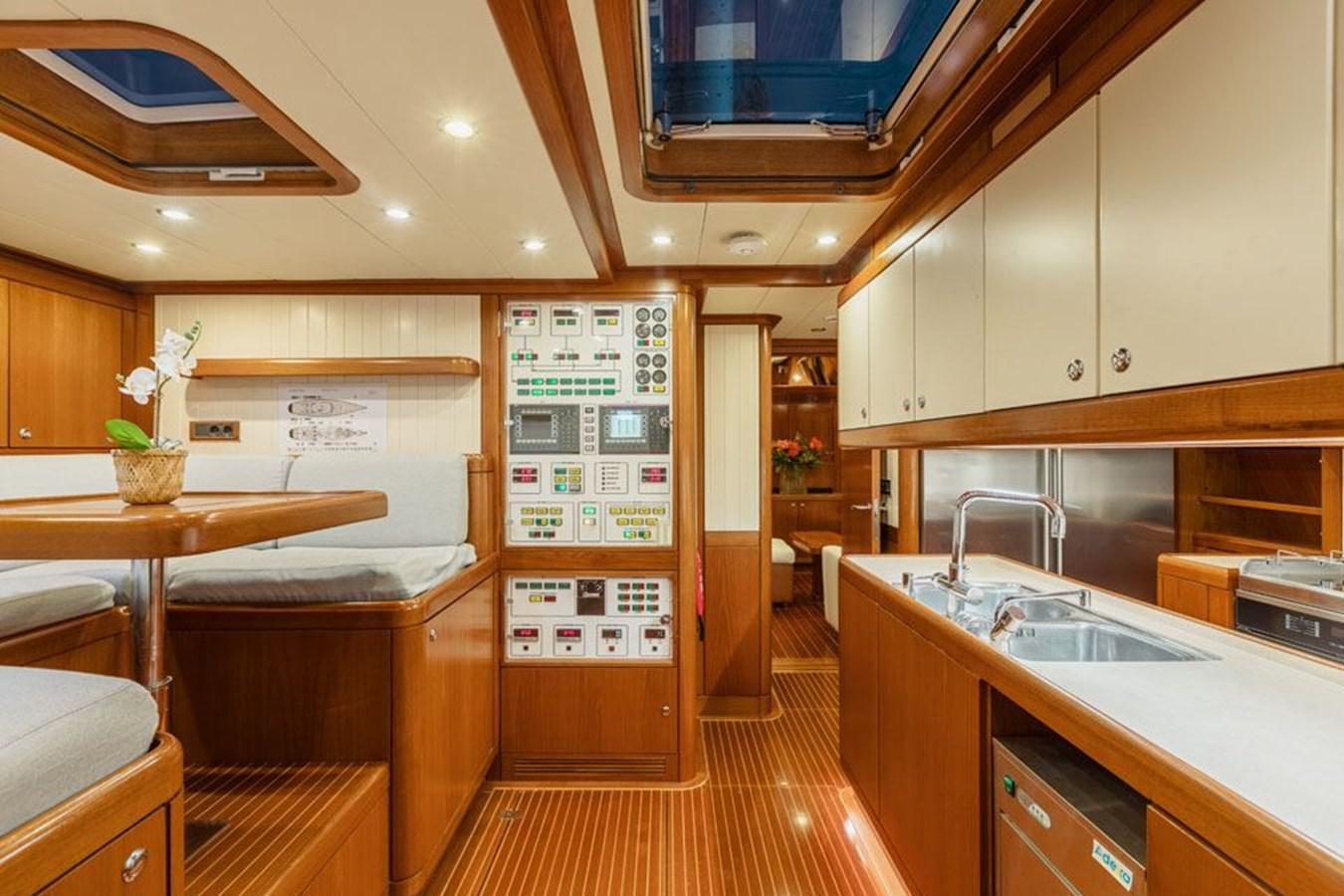 a kitchen with wooden cabinets aboard PAULINE AF SKANOR Yacht for Sale