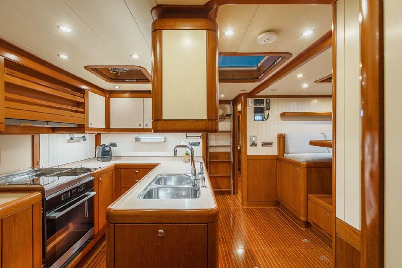 a kitchen with wooden cabinets aboard PAULINE AF SKANOR Yacht for Sale