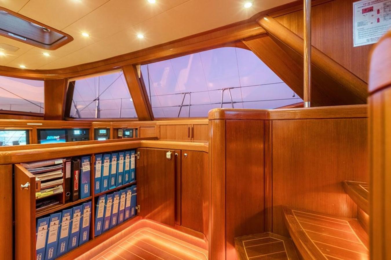 a library with bookshelves aboard PAULINE AF SKANOR Yacht for Sale