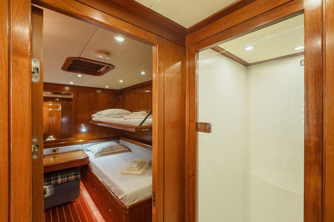 a room with a bed and a closet aboard PAULINE AF SKANOR Yacht for Sale