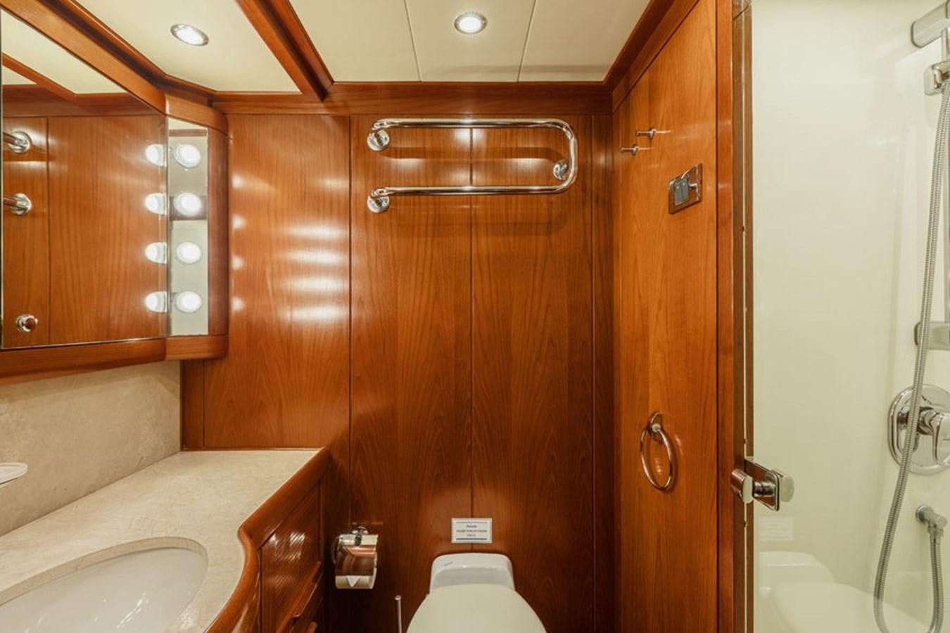 a bathroom with wooden cabinets aboard PAULINE AF SKANOR Yacht for Sale