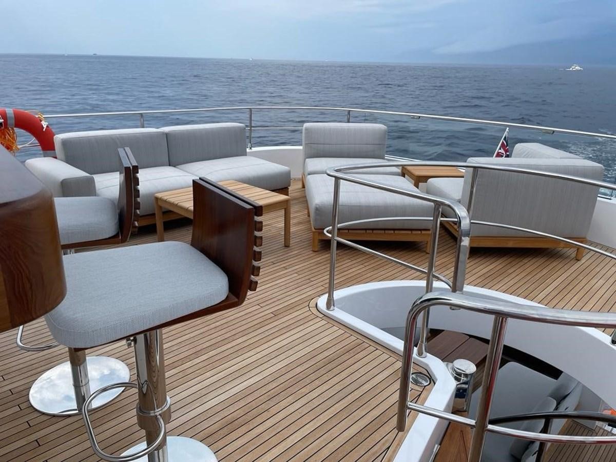 a deck with chairs and tables on it aboard KIKI Yacht for Sale