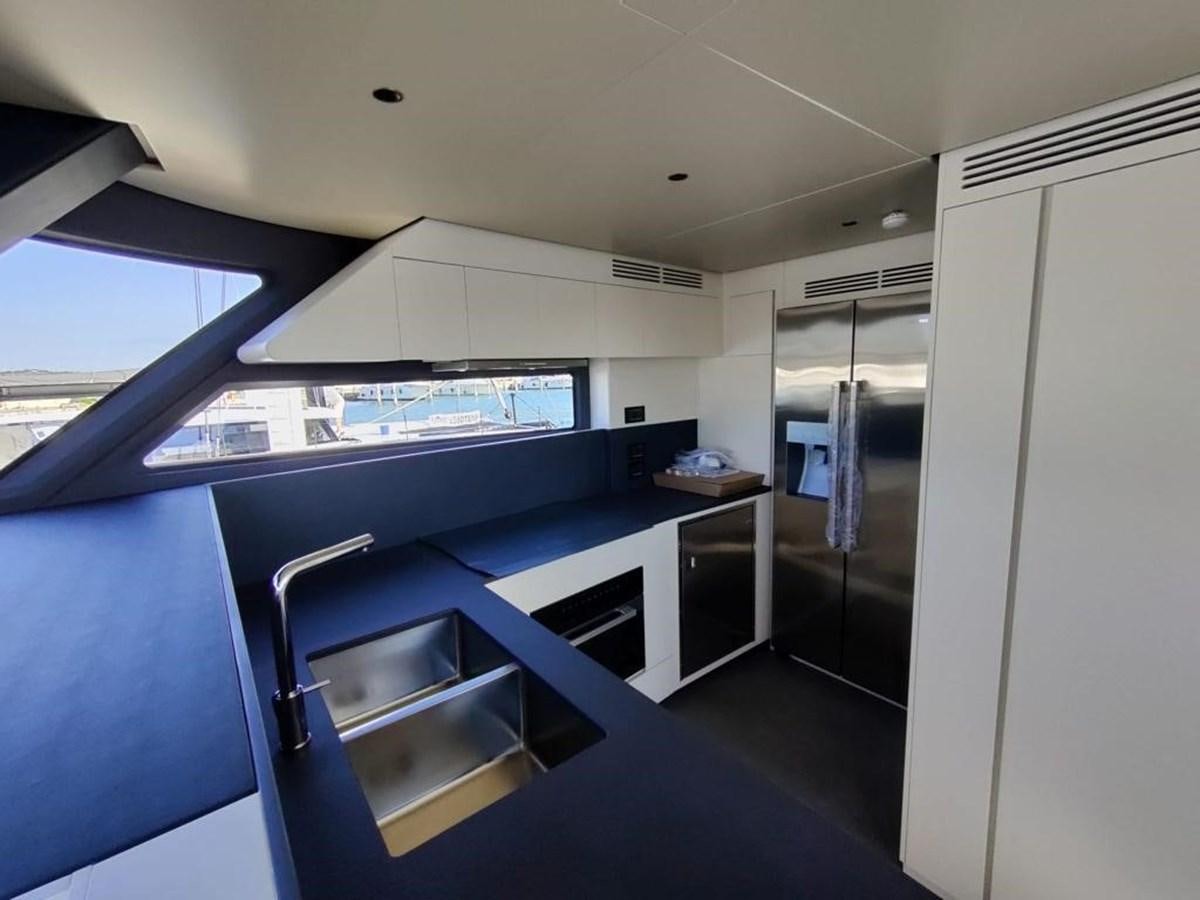 a room with a large window and a desk with a computer on it aboard KIKI Yacht for Sale