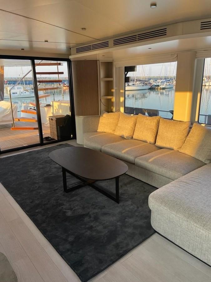 a living room with a large window aboard KIKI Yacht for Sale
