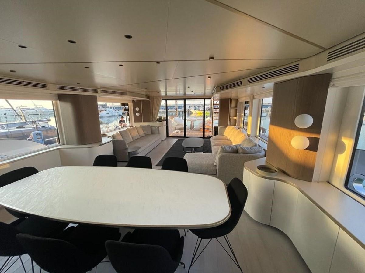 a room with a table and chairs aboard KIKI Yacht for Sale