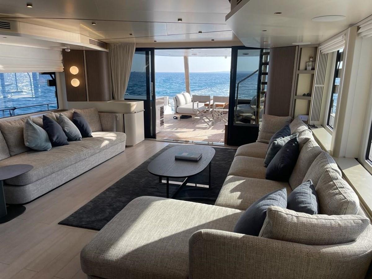 a living room with a large glass door aboard KIKI Yacht for Sale