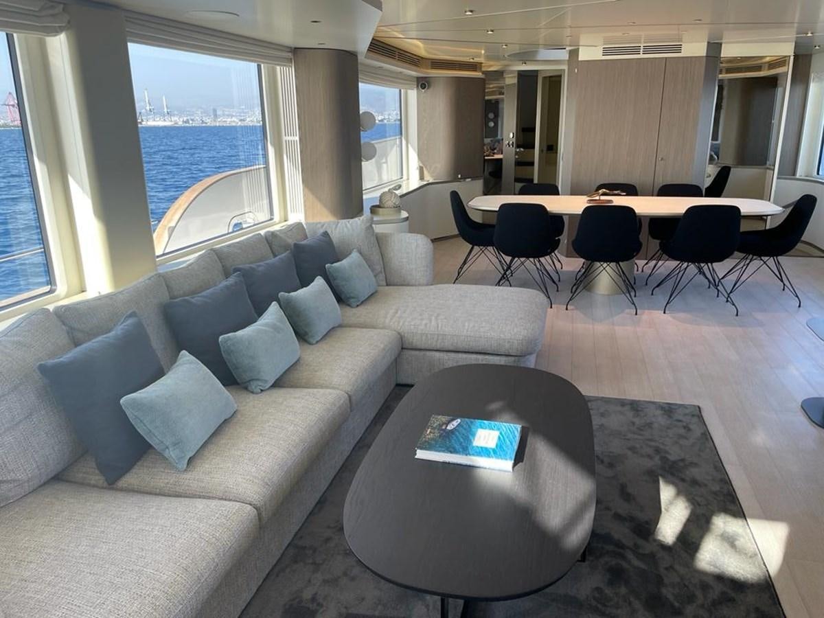 a living room with a couch and a table aboard KIKI Yacht for Sale