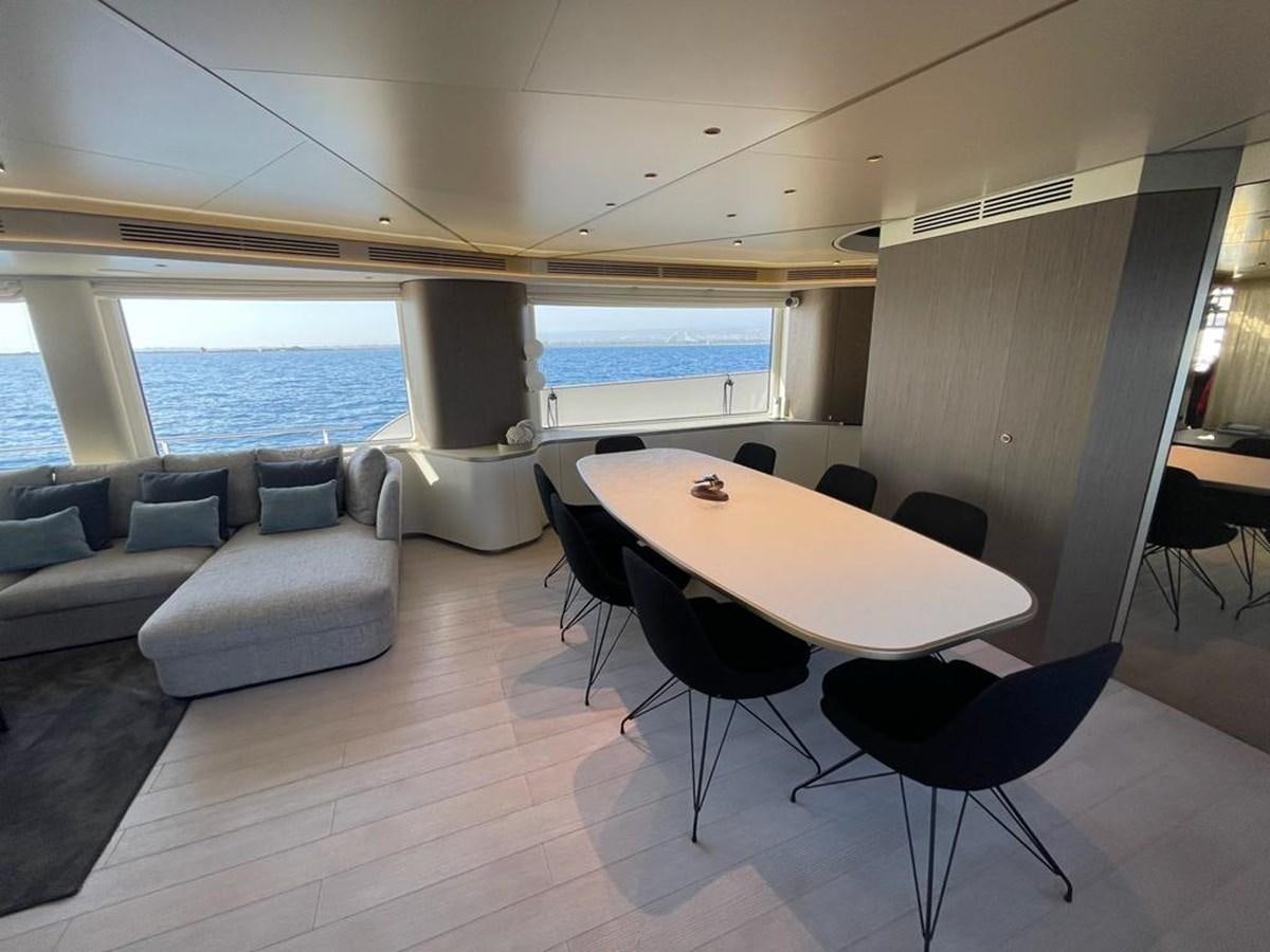a room with a table and chairs aboard KIKI Yacht for Sale