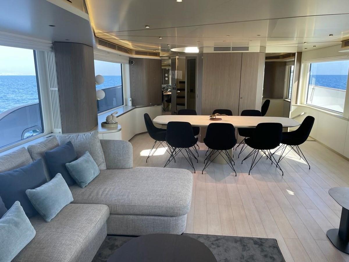 a room with a couch and a table and chairs aboard KIKI Yacht for Sale