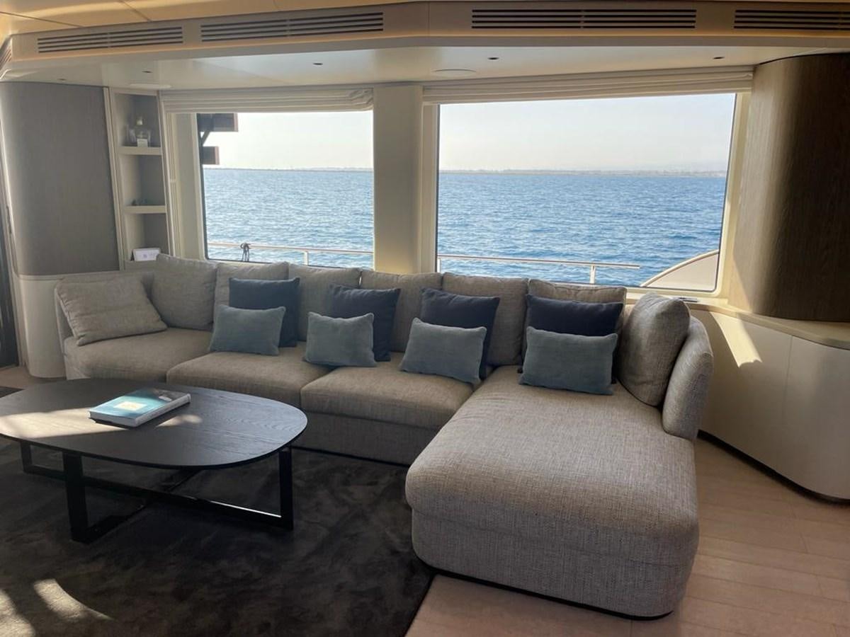 a living room with a large window aboard KIKI Yacht for Sale