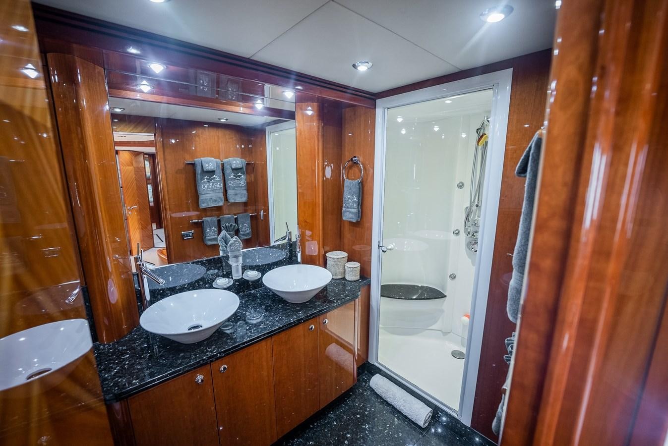 a bathroom with a sink and a shower aboard 105 MOTOR Yacht for Sale