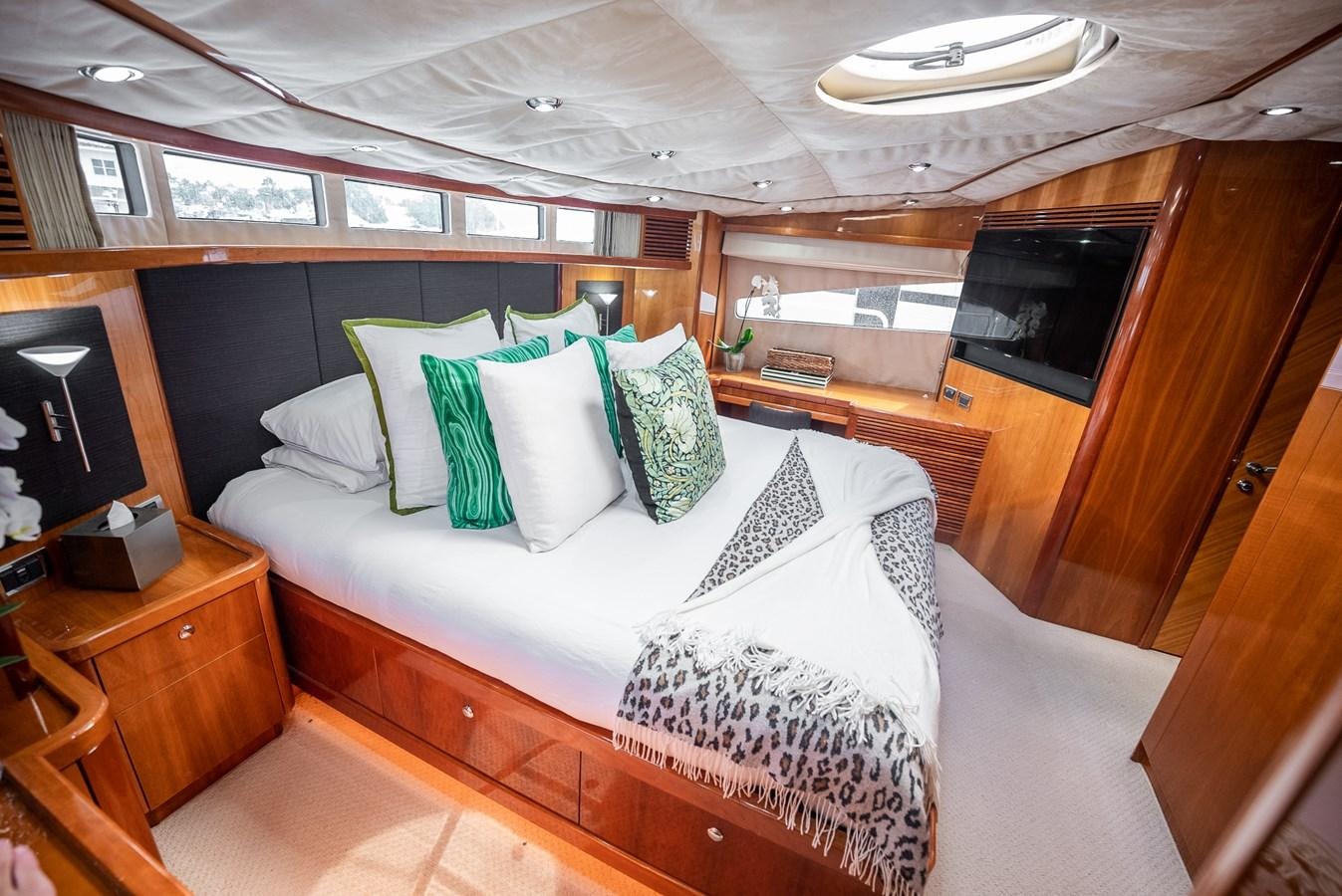 a bed with pillows and pillows aboard 105 MOTOR Yacht for Sale