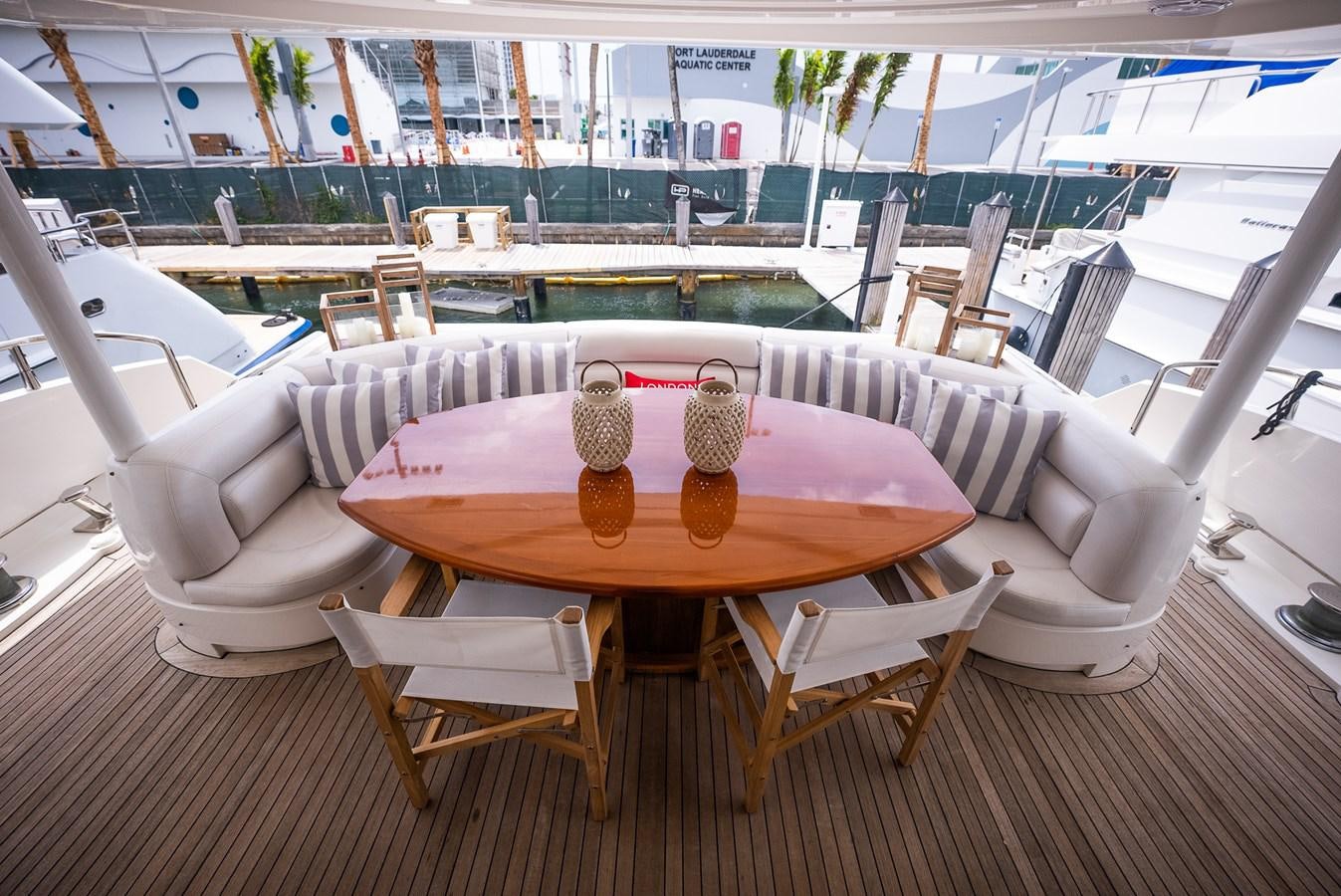 a table and chairs on a patio aboard 105 MOTOR Yacht for Sale