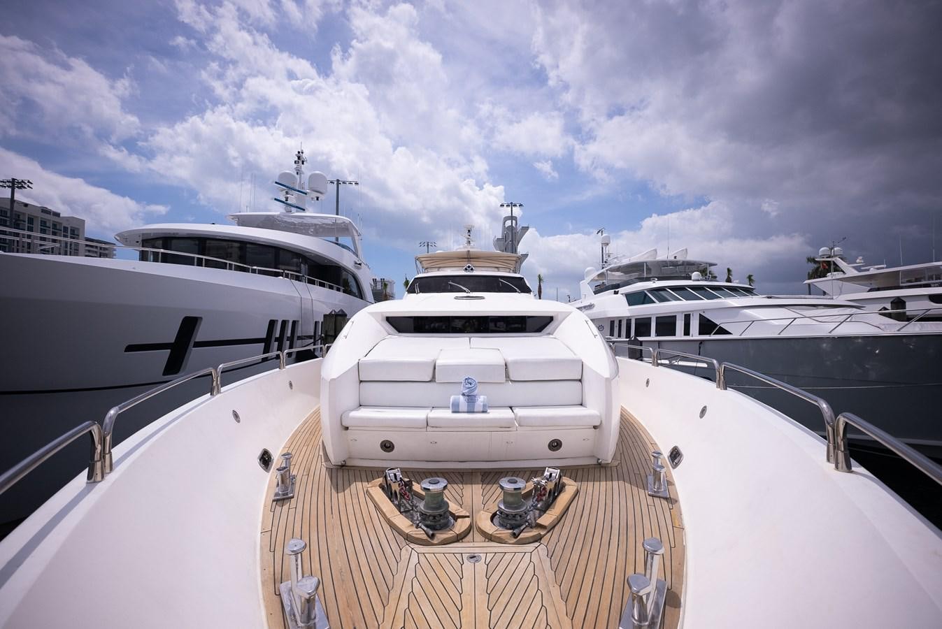 a deck with a boat and a couple of boats on it aboard 105 MOTOR Yacht for Sale