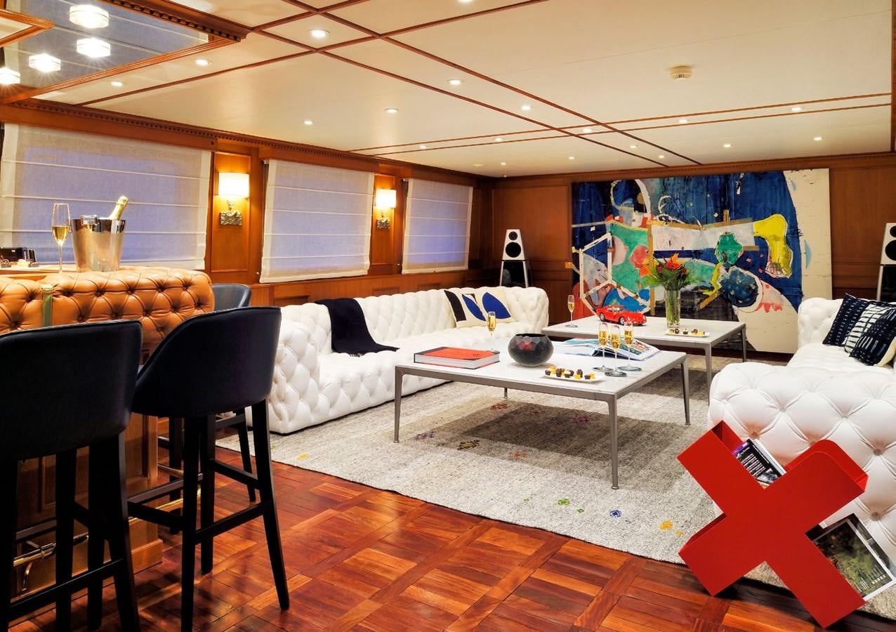 a living room with a large painting aboard SANOO Yacht for Sale