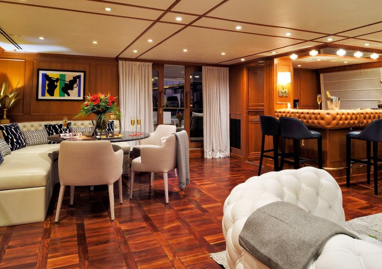 a room with a table chairs and a couch aboard SANOO Yacht for Sale