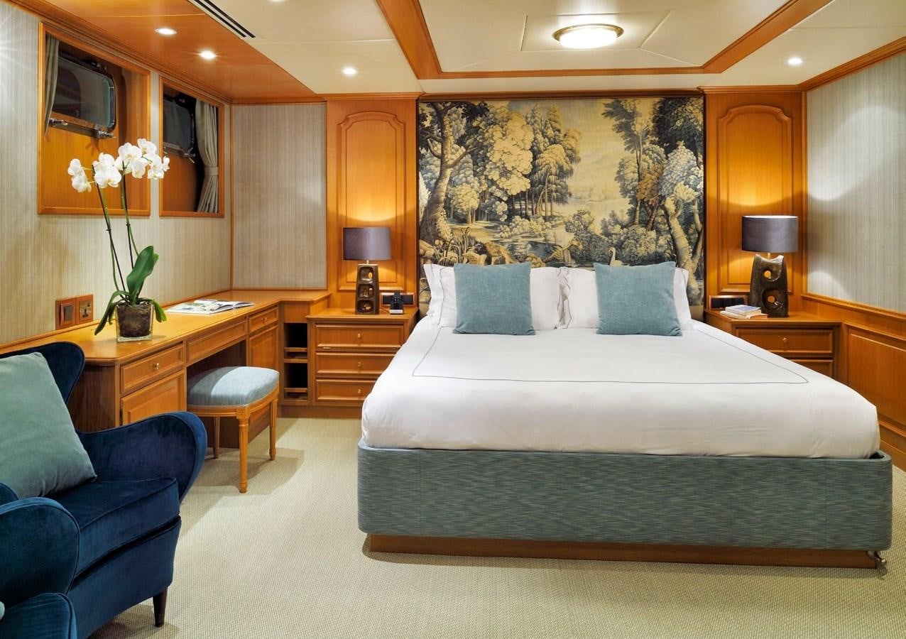 a bedroom with a bed and a chair aboard SANOO Yacht for Sale