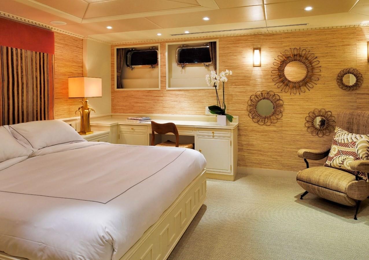 a bedroom with a bed and a desk aboard SANOO Yacht for Sale