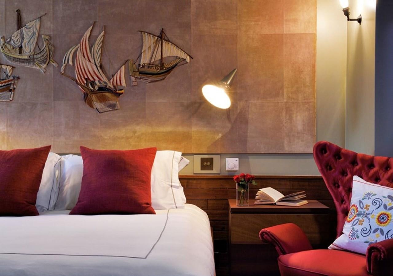 a room with a couch and a table with a couch and a lamp aboard SANOO Yacht for Sale