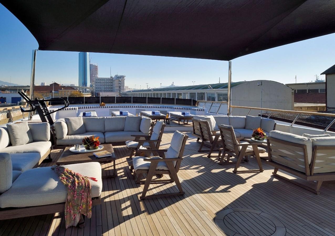 a patio with a table and chairs aboard SANOO Yacht for Sale