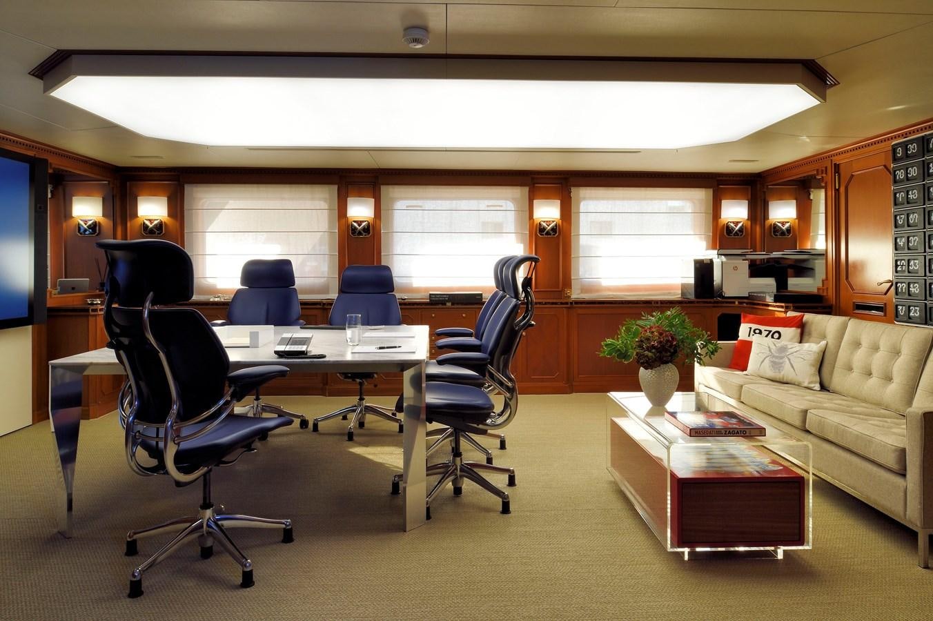 a room with a couch and a table and chairs aboard SANOO Yacht for Sale