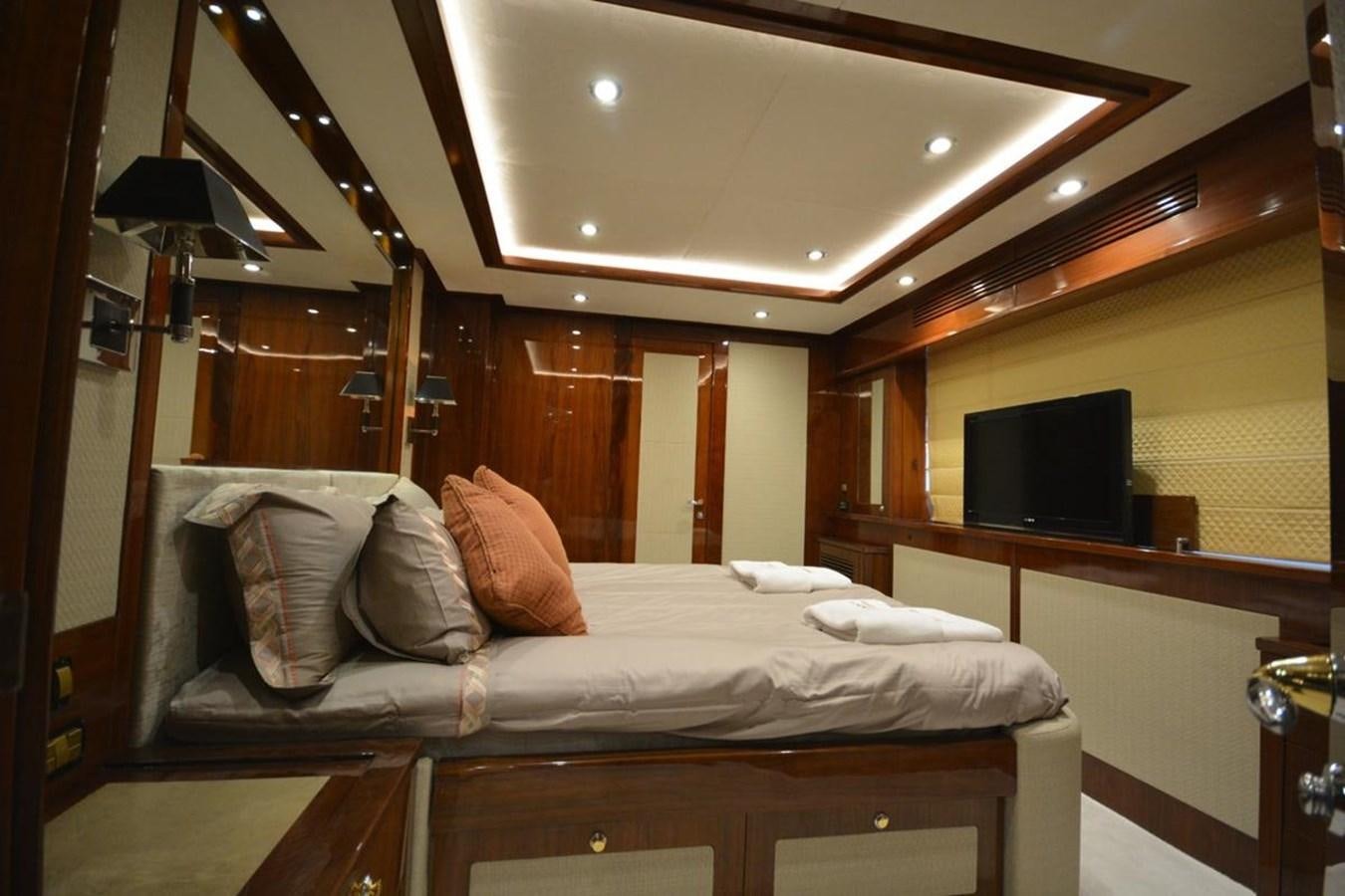 a bed with pillows and a television aboard SUNSEEKER 34M Yacht for Sale