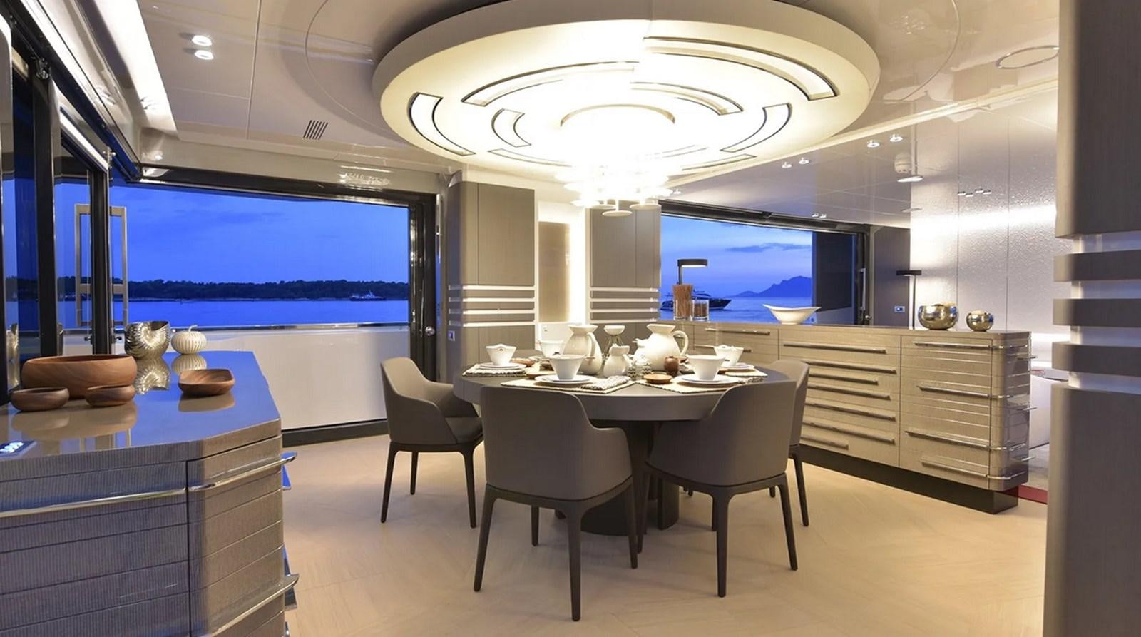 a large kitchen with a large table and chairs aboard ARCADIA 100 Yacht for Sale