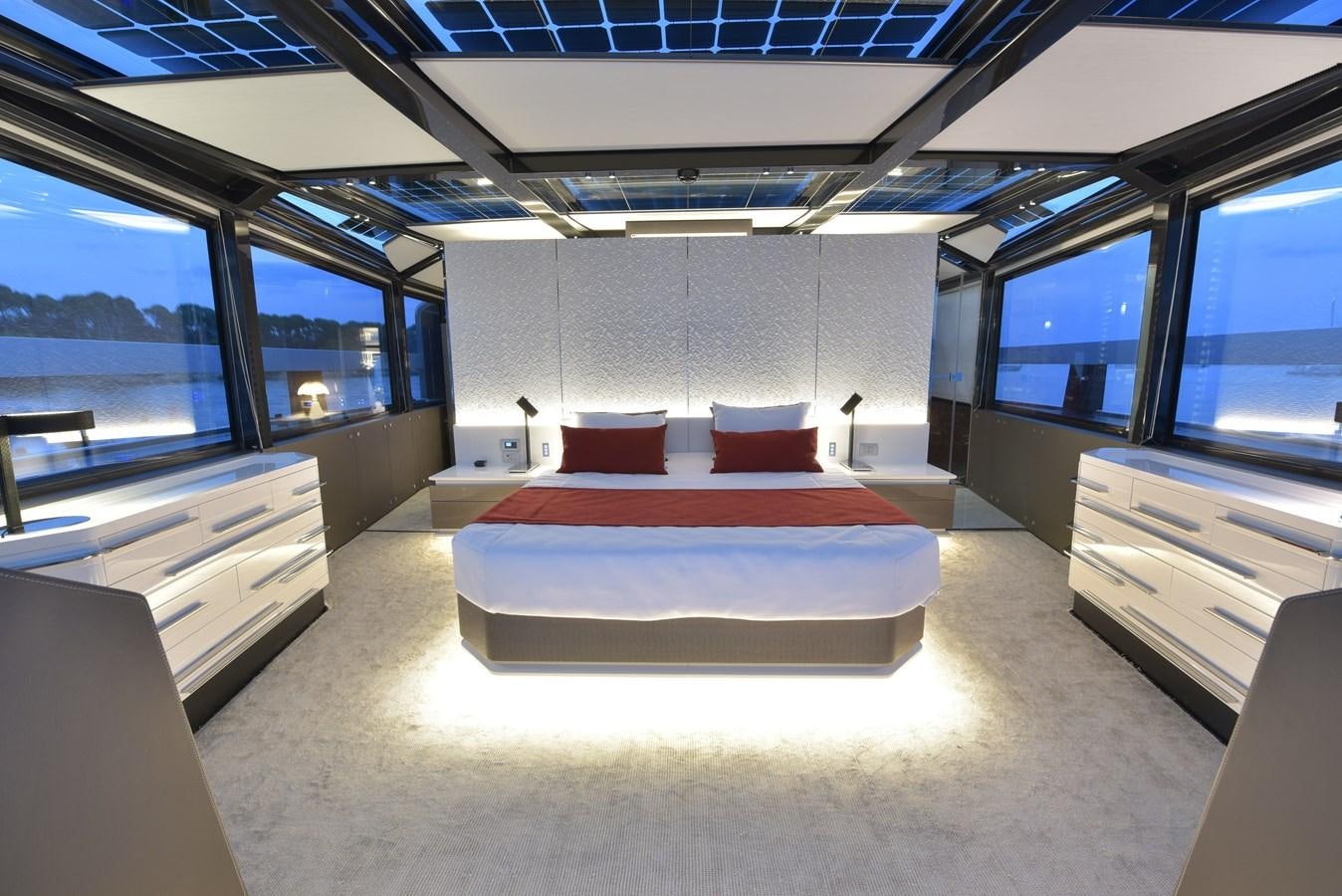 a room with a bed and a desk aboard ARCADIA 100 Yacht for Sale