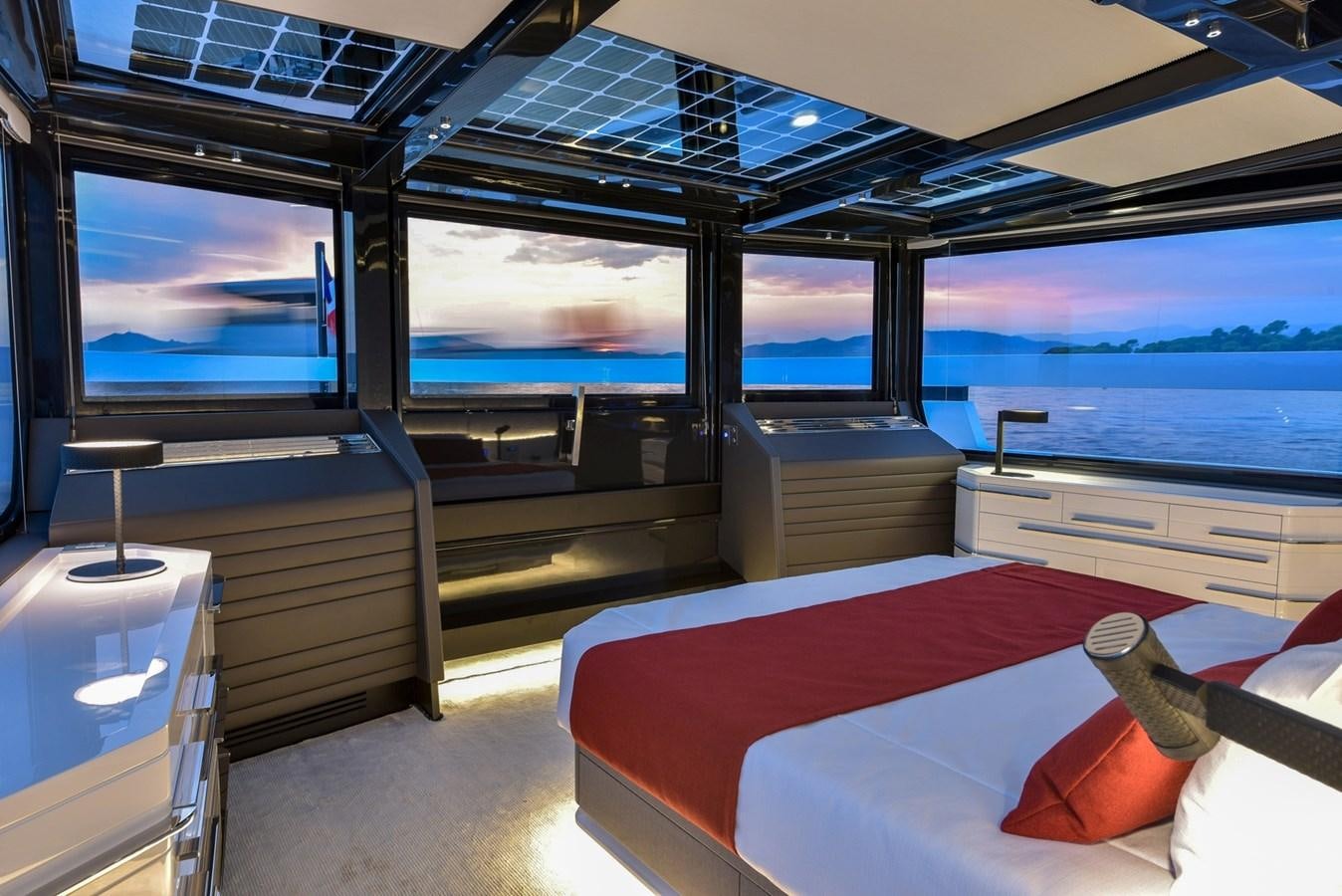 a room with a bed and a large window aboard ARCADIA 100 Yacht for Sale