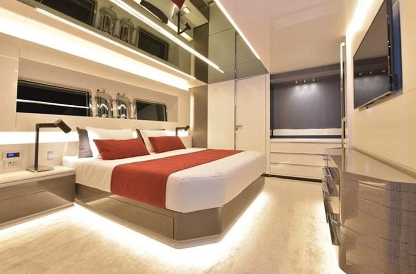 a room with a bed and a mirror aboard ARCADIA 100 Yacht for Sale