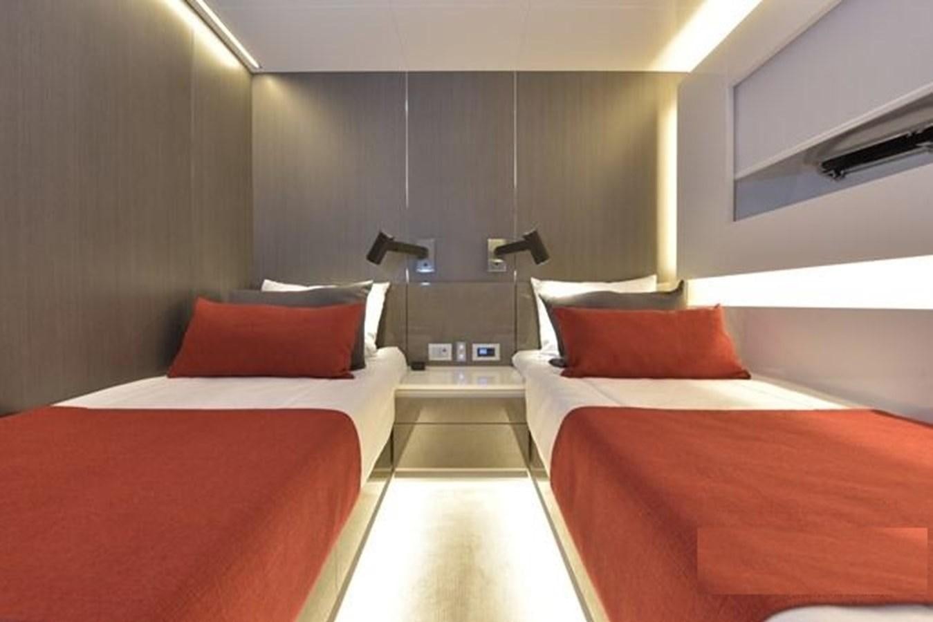 a room with beds and a chair aboard ARCADIA 100 Yacht for Sale