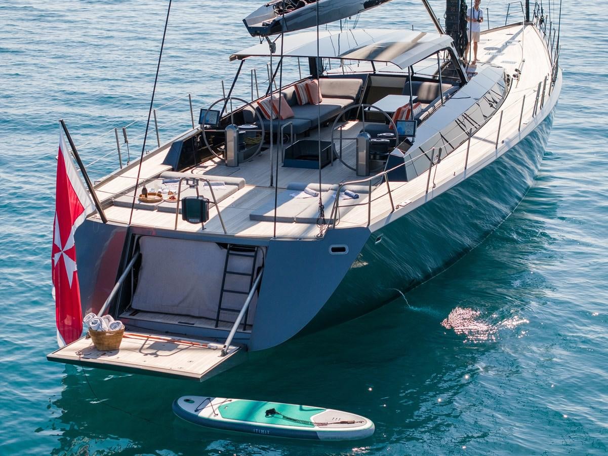 a boat with a red and white stripe on the front aboard WHIMSEA Yacht for Sale