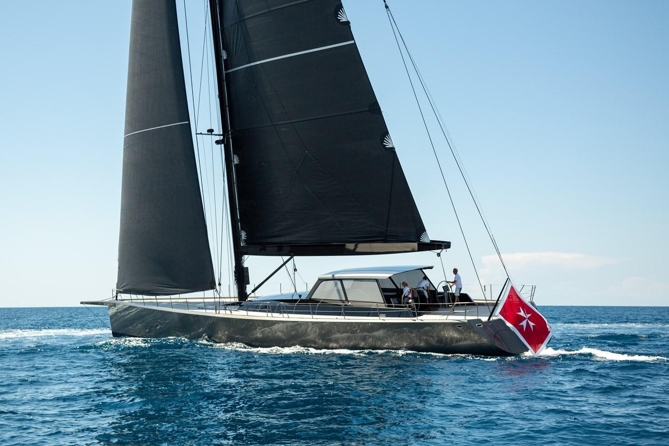 a sailboat with a red sail aboard WHIMSEA Yacht for Sale