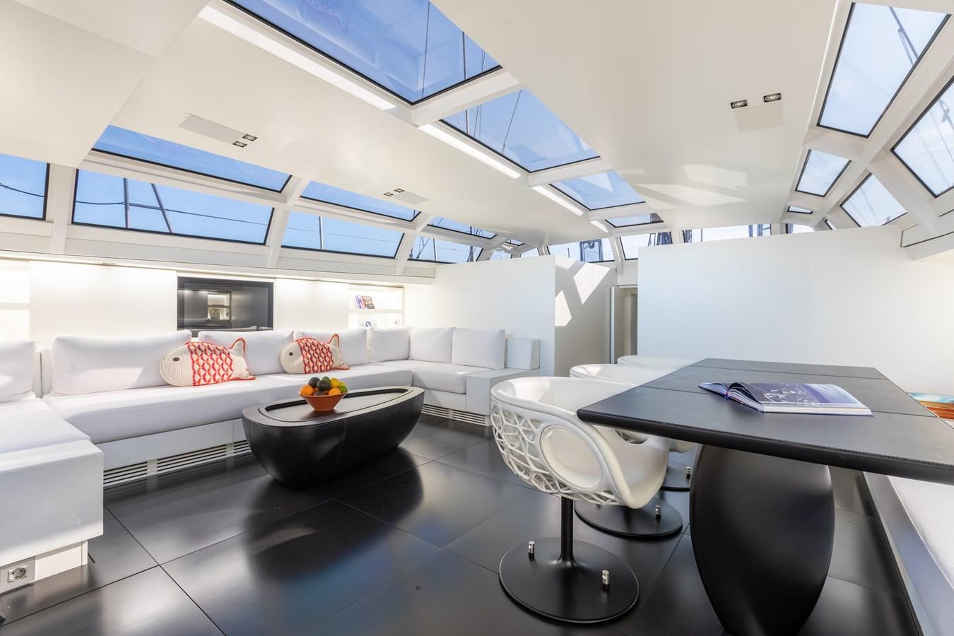 a room with a couch and a table aboard WHIMSEA Yacht for Sale