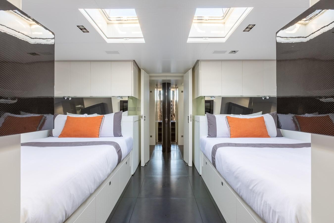 a room with beds and a door aboard WHIMSEA Yacht for Sale