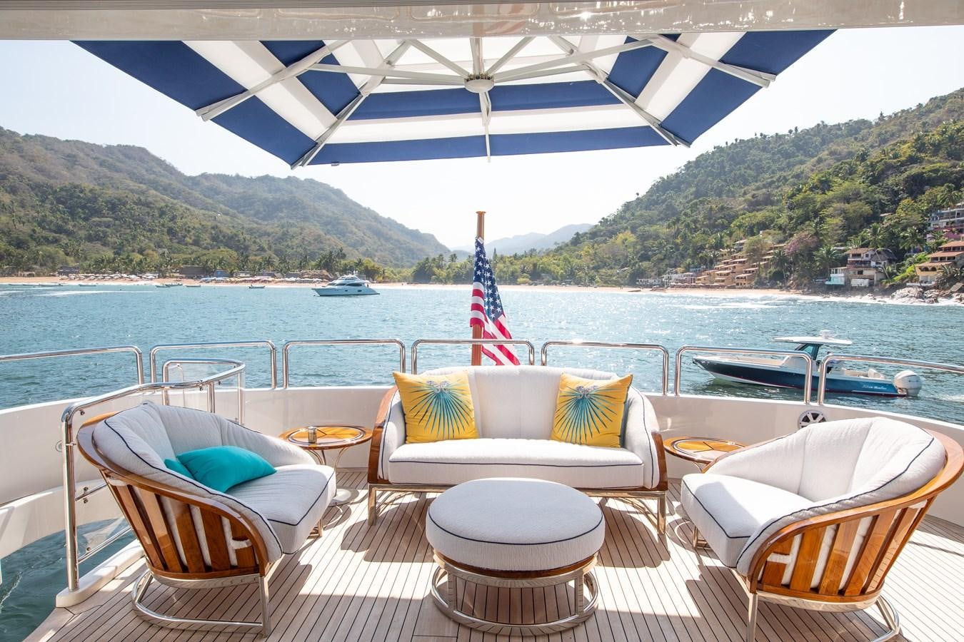 a table and chairs on a deck overlooking a body of water aboard FELICITA Yacht for Sale