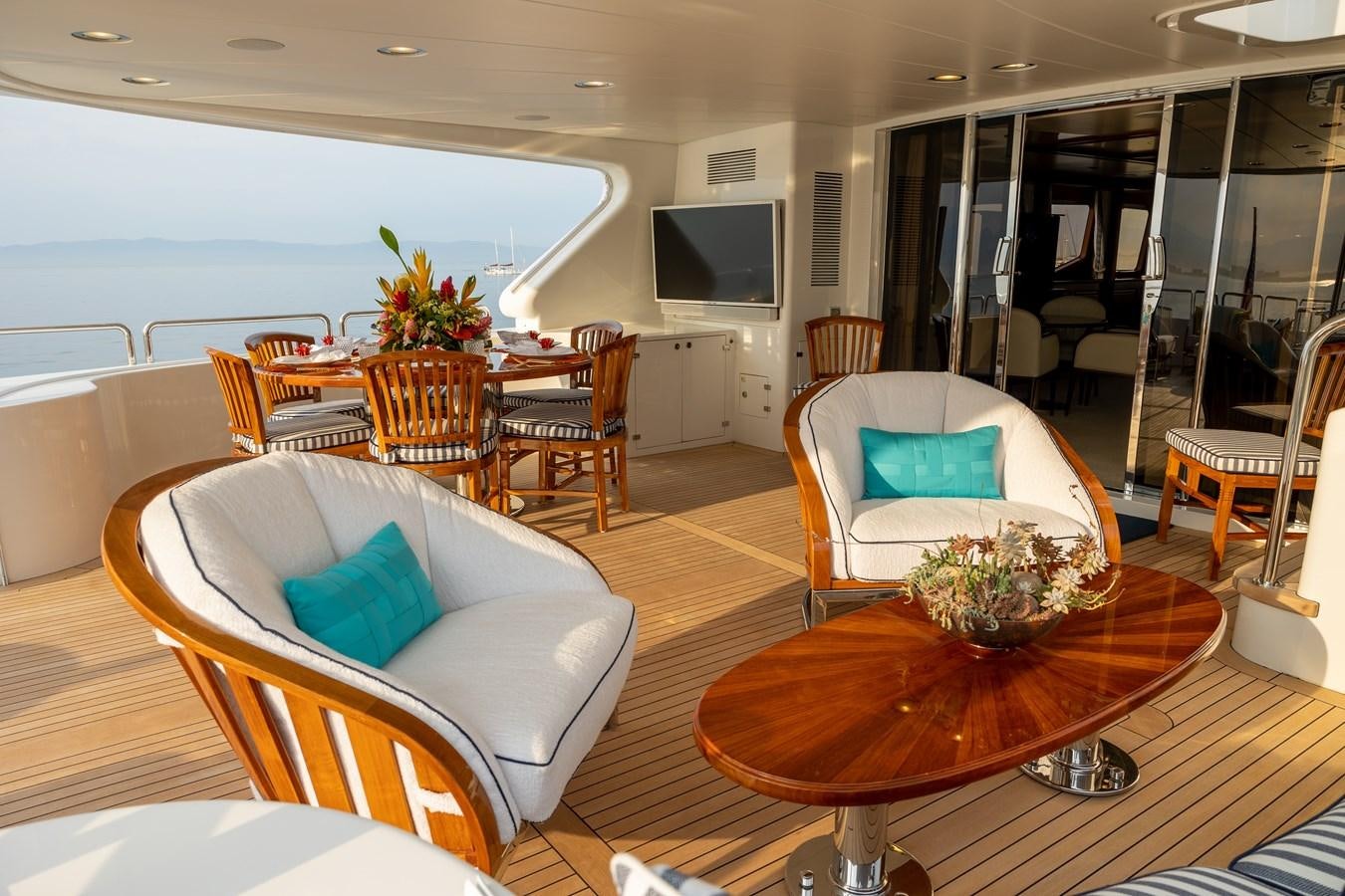 a living room with a table and chairs aboard FELICITA Yacht for Sale