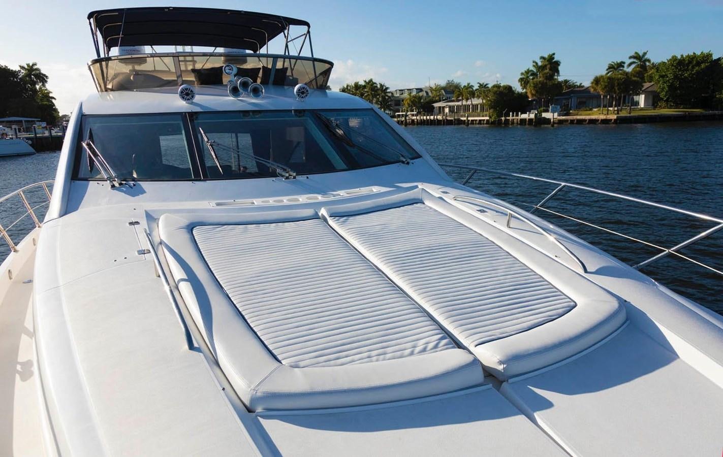 a white boat with a blue front aboard UNFORGETTABLE Yacht for Sale