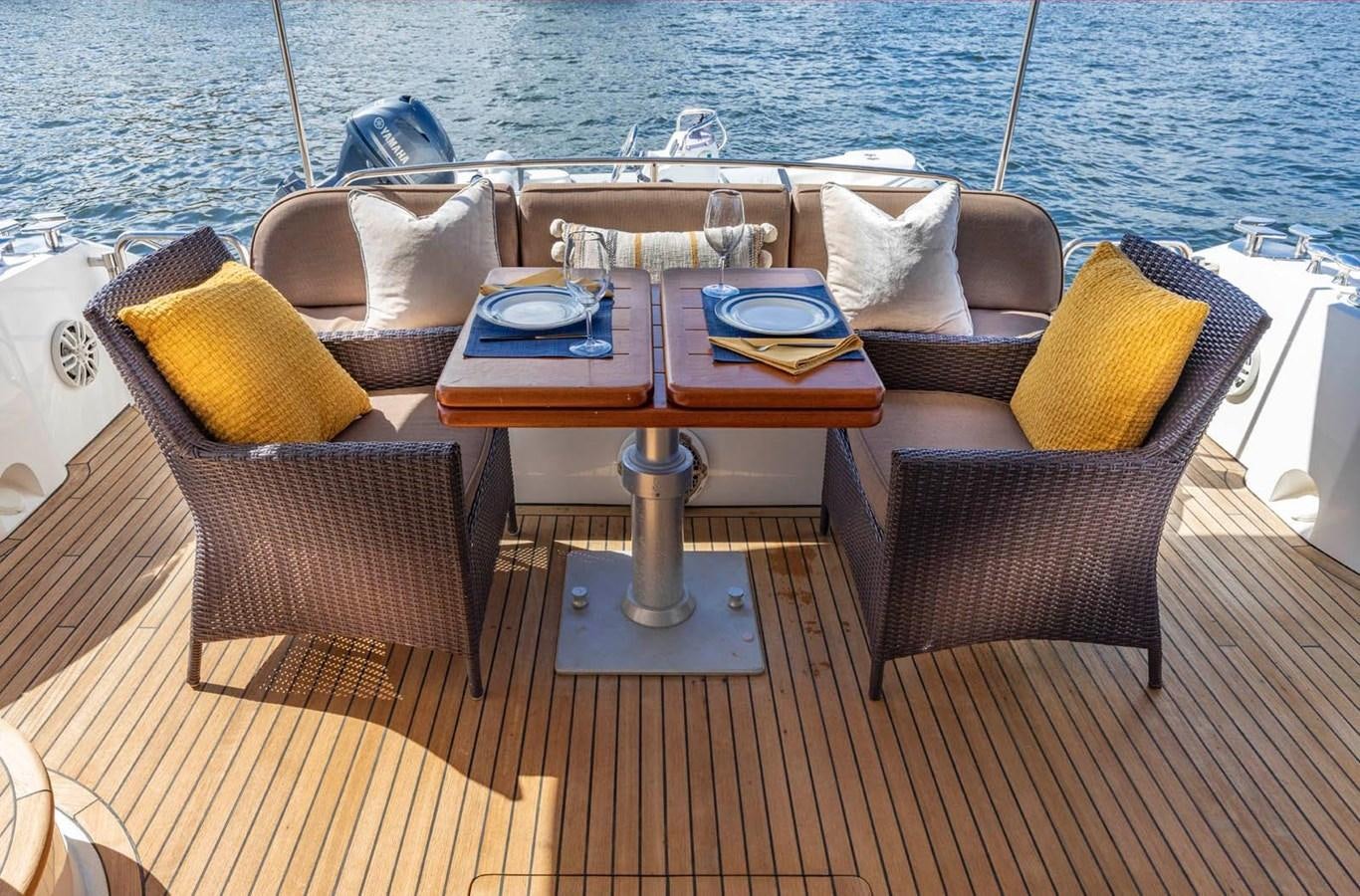 a table and chairs on a boat aboard UNFORGETTABLE Yacht for Sale